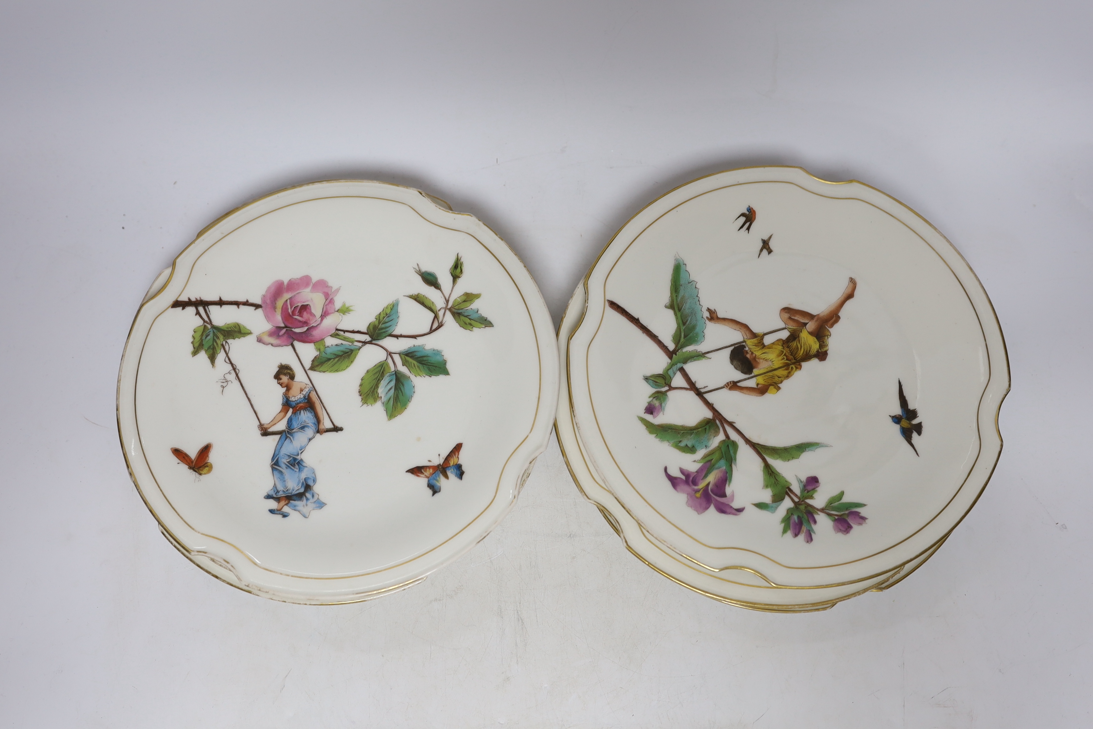 A set of eight late 19th century French Porcelain dessert plates decorated with scenes of figures on branched swings surrounded by flowers, 24cm diameter